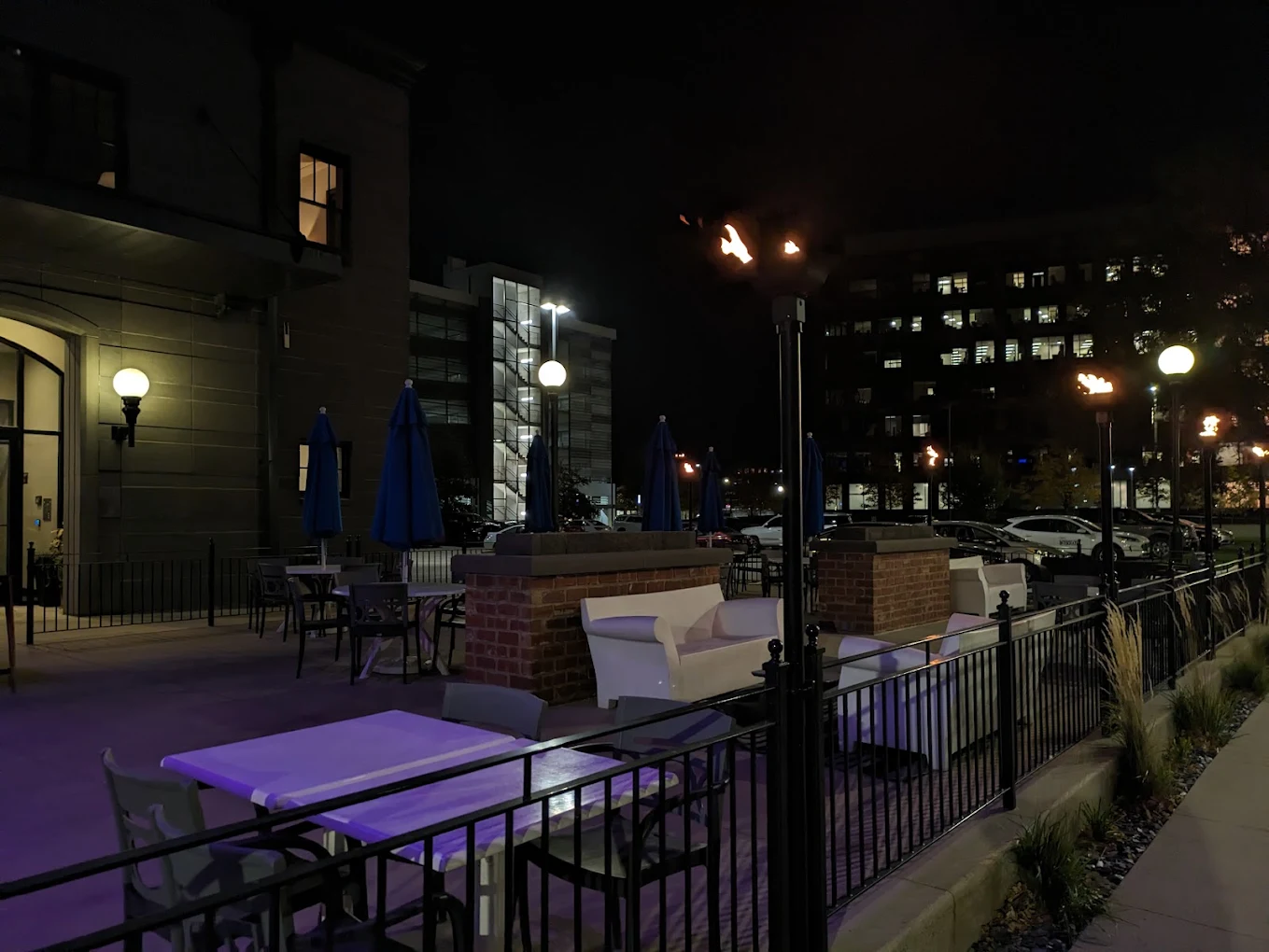Black Sheep Social Club rooftop seating area with a round gas fire pit and outdoor gas torches